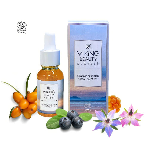 Viking Beauty Secrets organic certified glow facial oil with packaging, berries, and flowers on a white background
