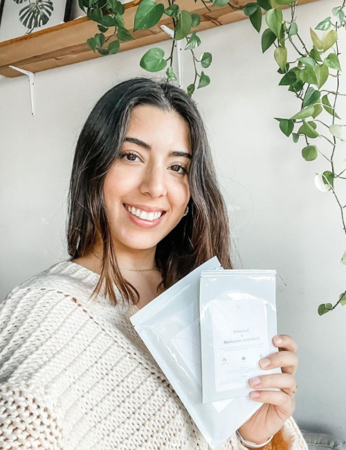 woman holding package of 2 olecea masks