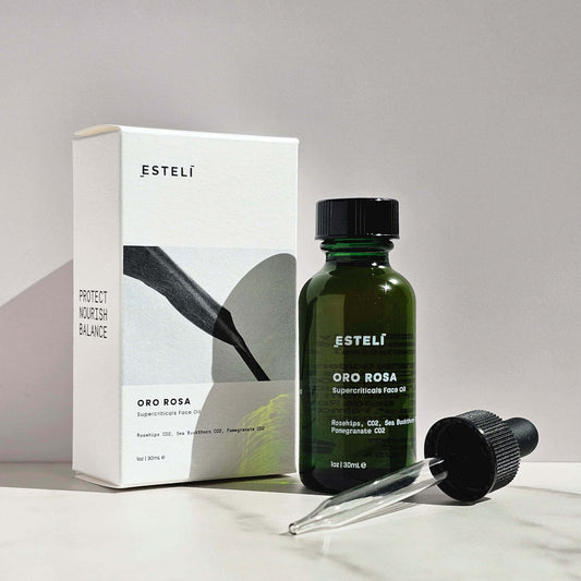 Esteli Oro Rosa Supercriticals Face Oil Bottle with dropper in front of the product box