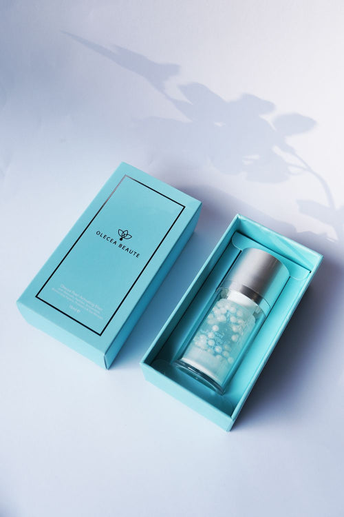 A bottle of Pearl Activating Elixir Serum by Olecea, designed for promoting healthier, more radiant skin with advanced pearlescent beads, hyaluronic acid, and other skin-care ingredients.