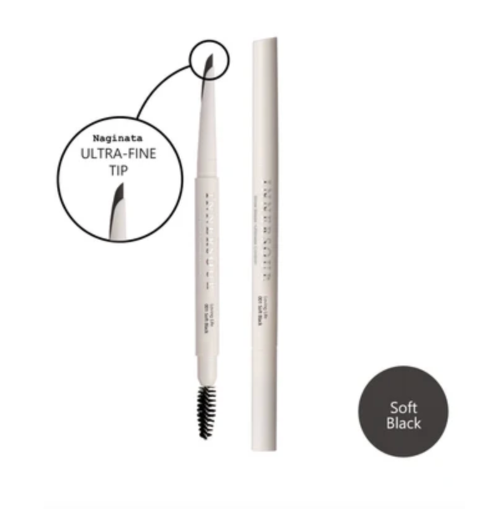 An eyebrow pencil shown upright with a spoolie end visible, alongside its cap. A circular inset highlights the fine tip, and a dark gray circle reads 'Soft Black' to indicate the shade.