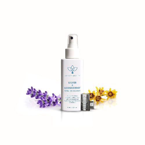 A white spray bottle labeled Silver + Licorice Root Protective Facial Spray by Olecea, indicating it is a skincare product.