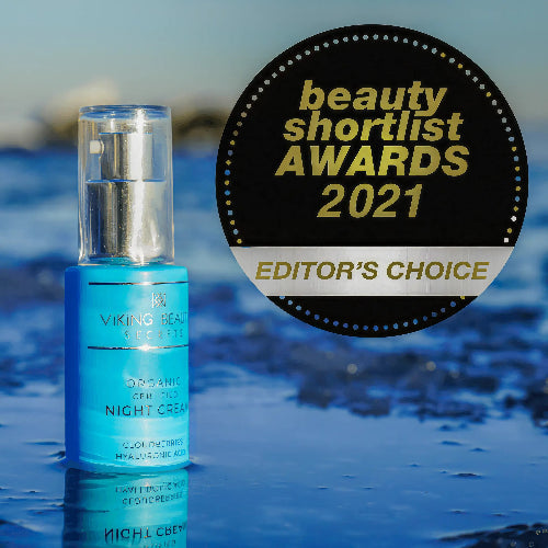 Blue skincare bottle with 'Editor's Choice' award badge on a blurred natural background