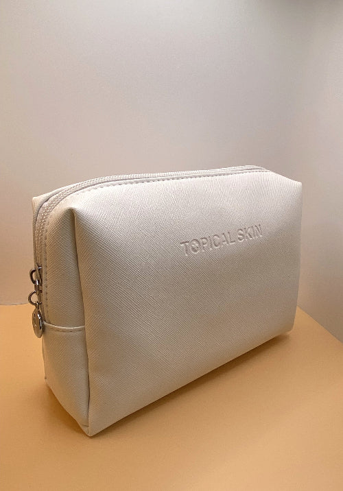 A white, crosshatched, patterned travel-size cosmetic bag with a water-resistant exterior and an easy-to-clean interior.