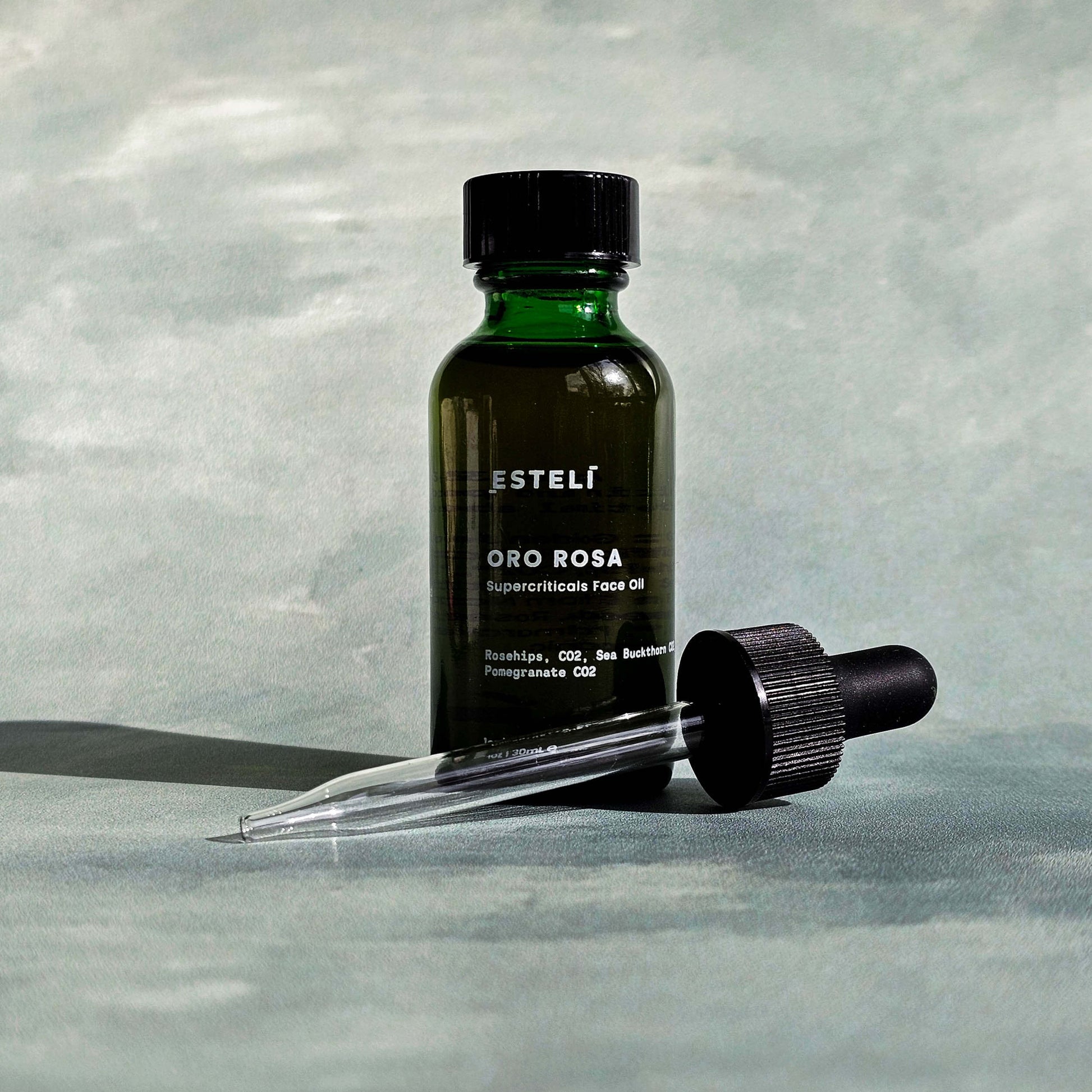 Bottle of Esteli Oro Rosa Nourish Facial Oil with glass dropper


