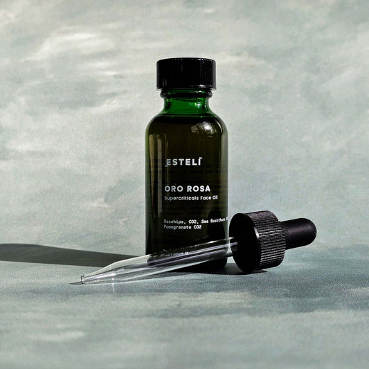 Bottle of Esteli Oro Rosa Nourish Facial Oil with glass dropper

