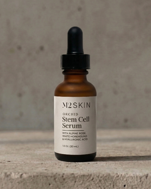 M2SKIN orchid stem cell serum bottle with dropper on a concrete surface
