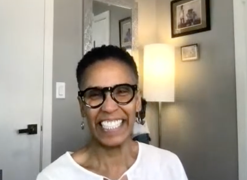 Robyn wearing glasses smiling in a home setting