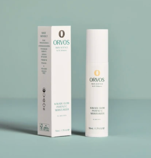 Orvos Kakadu Glow Portion C Moisturizer shown with its white packaging box and white cylindrical bottle on a solid pale blue-green background.