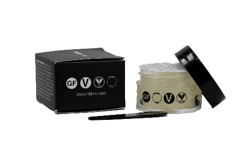 Jar of cream with black lid and packaging on a white background